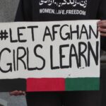 Protesters hold #Let Afghan Girls Learn signs