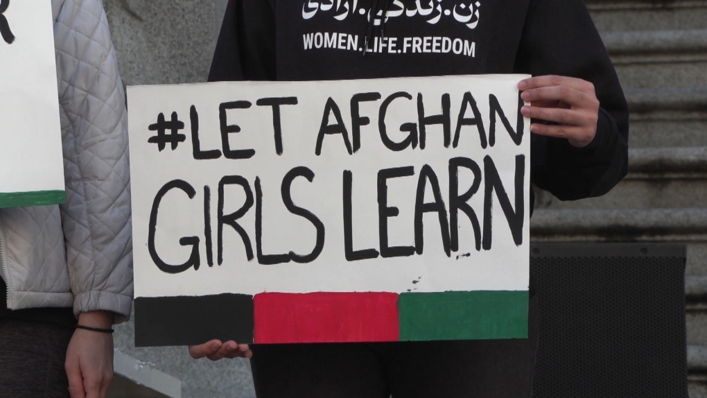 Protesters hold #Let Afghan Girls Learn signs