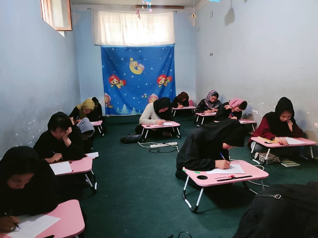 Afghan girls learn in a secret location despite the ban on education.
